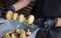 ÃÂ¡hef cooks mushrooms. Man in cooking uniform and gloves prepare champignon skewers for grilling. Outside picnic party kitchen